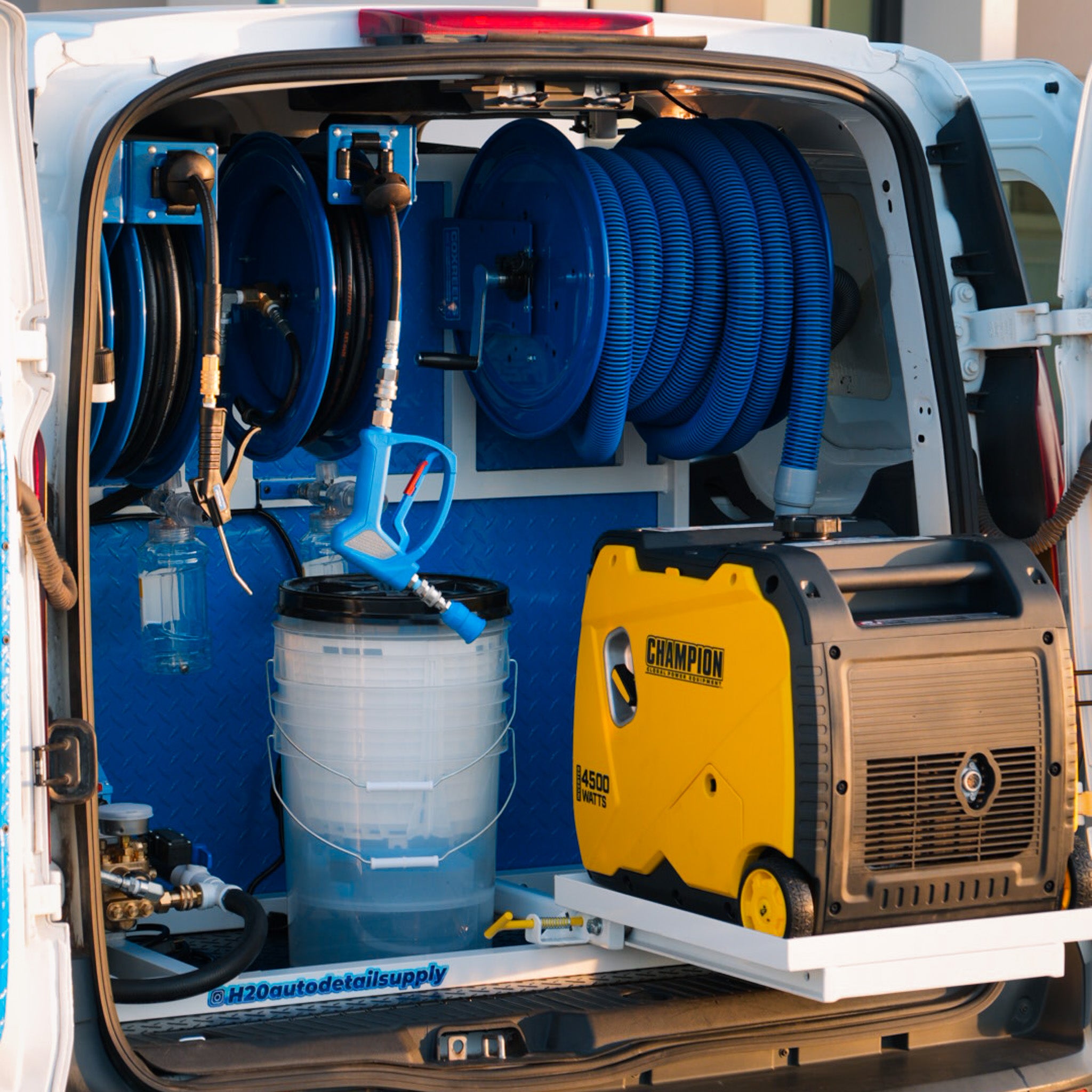 Organized rear view of a Pure Power mobile detailing van showcasing a Champion 4500-watt generator, mounted hose reels, buckets, and spray system setup in Phoenix, Arizona